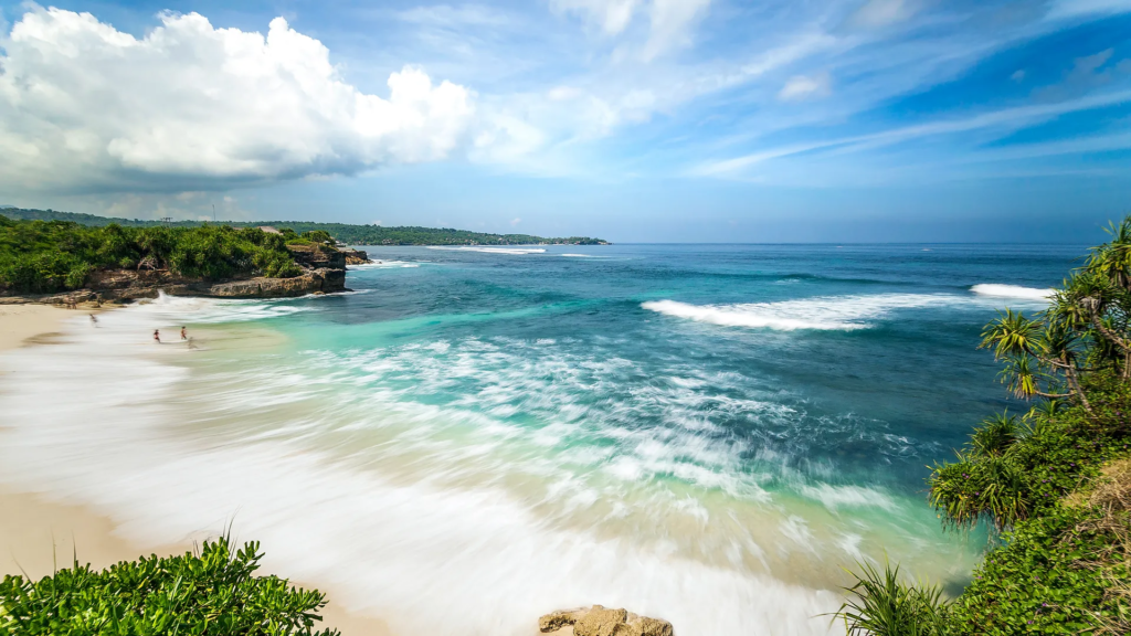 white sand beach with clear blue water.